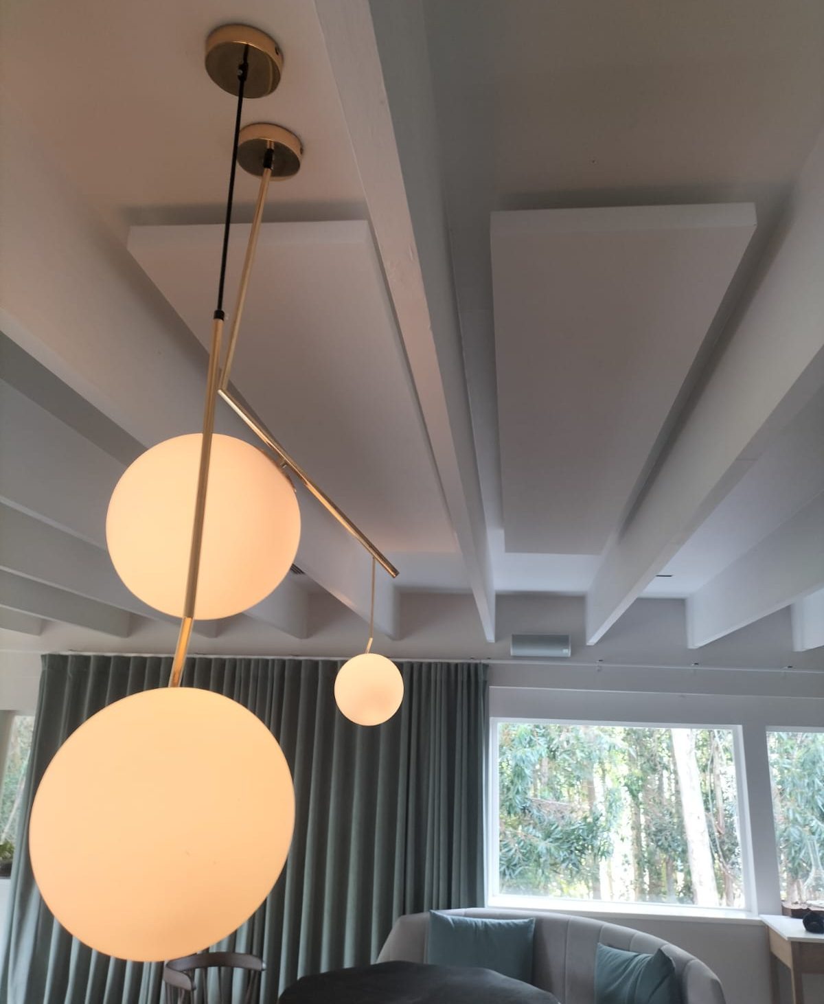 Interior with suspended lighting and acoustic ceiling elements
